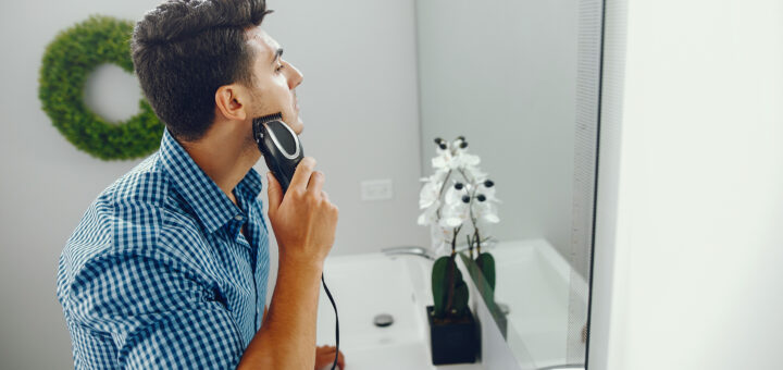 man is shaving his face using the best electric shaver for men