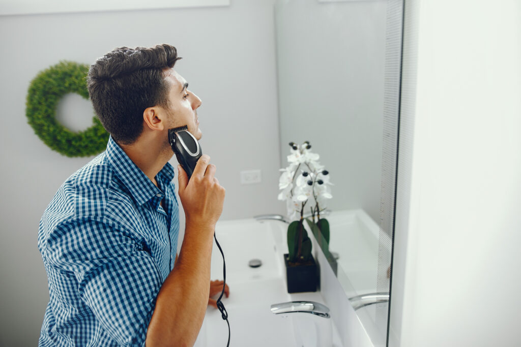 man is shaving his face using the best electric shaver for men