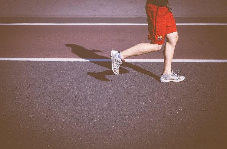 a man's legs while he jogs 