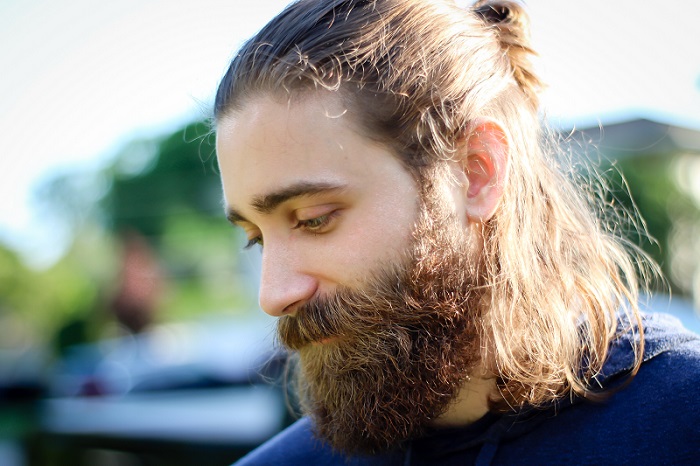 a young man with a thick beard