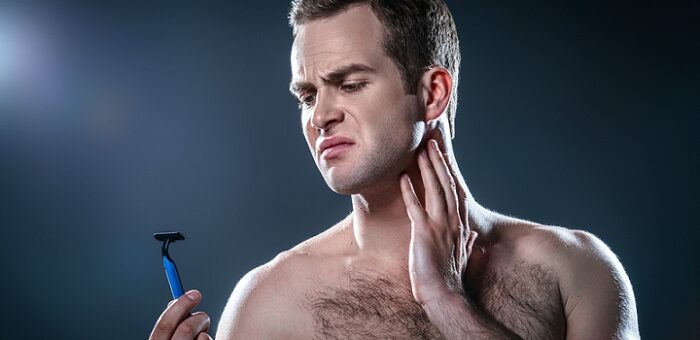 a young man with a shaving razor