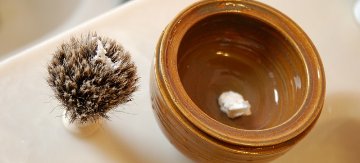 a shaving scuttle bowl and a brush