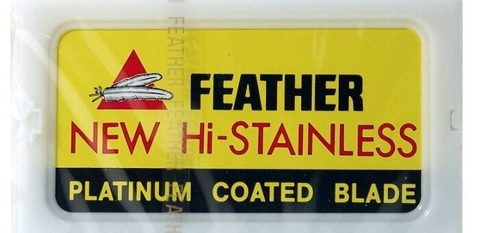 a yellow packaging of Feather razor blades
