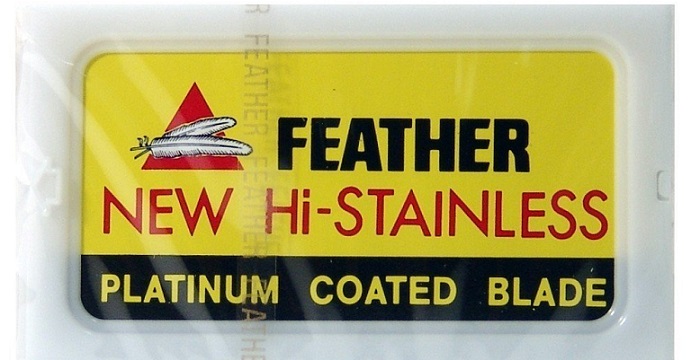 a yellow packaging of Feather razor blades