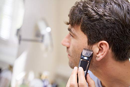 man using philips norelco shaver
