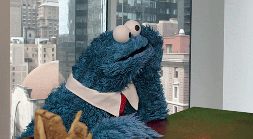 cookie monster is waiting patiently while sitting down in the office