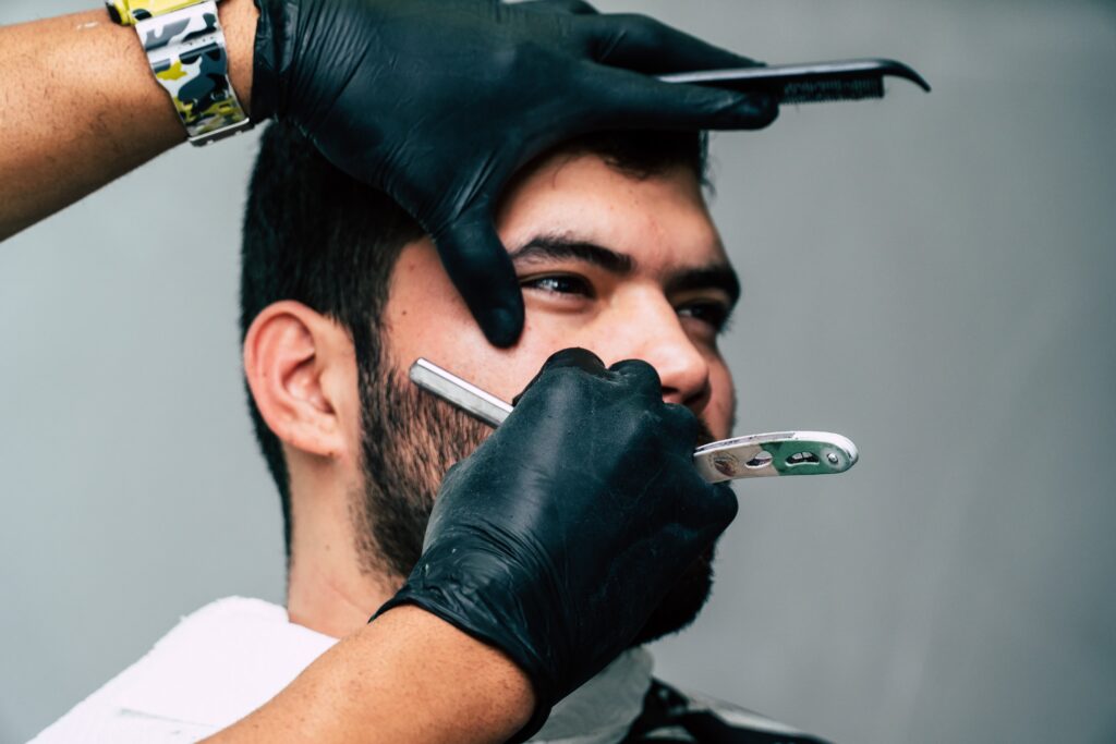 man getting his beard shaved