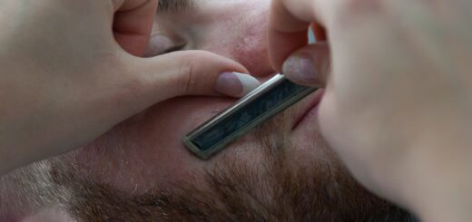 man getting his beard shaved