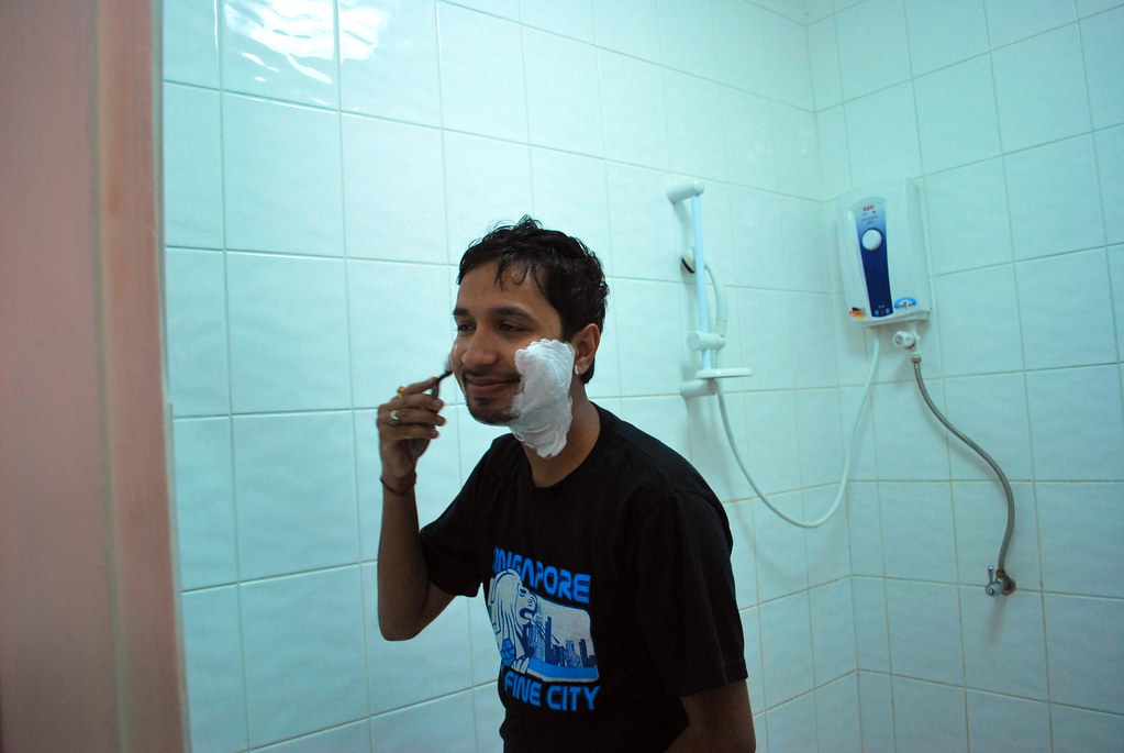 men shaving inside the bathroom